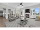 The neutral living room features a fireplace, shiplap accent wall, and a stylish rug at 1095 Saltwater Cir, Johns Island, SC 29455