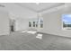 Spacious main bedroom with tray ceiling, large windows with scenic view and gray carpeted floors at 1095 Saltwater Cir, Johns Island, SC 29455