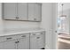 Well-lit pantry features gray cabinetry with contrasting hardware and bright white quartz countertops at 1095 Saltwater Cir, Johns Island, SC 29455