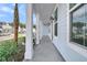 The side porch has white pillars and offers shade and a view of the neighborhood at 1095 Saltwater Cir, Johns Island, SC 29455