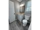 Cozy bathroom with new plank flooring, featuring a single sink vanity, a framed mirror, and a toilet at 1102 Hampton Ct, Summerville, SC 29486