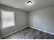 A bright bedroom with a window and modern gray flooring at 1102 Hampton Ct, Summerville, SC 29486