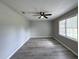 A spacious room with a ceiling fan, light gray plank flooring, and a window for natural light at 1102 Hampton Ct, Summerville, SC 29486