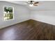 Bright bedroom with wood-look flooring features a ceiling fan, fresh neutral paint, and natural light at 1128 Peninsula Cove Dr, Charleston, SC 29492