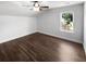 An inviting bedroom is enhanced by wood-look floors, natural light, a ceiling fan, and neutral paint at 1128 Peninsula Cove Dr, Charleston, SC 29492