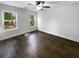 Bright bedroom featuring hardwood floors, two windows, ceiling fan, and neutral paint at 1128 Peninsula Cove Dr, Charleston, SC 29492