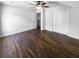 Bright bedroom with wood-look flooring features a ceiling fan, bi-fold closet doors, and neutral paint at 1128 Peninsula Cove Dr, Charleston, SC 29492