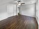 Bedroom offers wood-look flooring, a ceiling fan, closet doors, and fresh neutral paint throughout at 1128 Peninsula Cove Dr, Charleston, SC 29492
