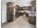 Spacious kitchen with stainless steel appliances and dark wood cabinetry at 1128 Peninsula Cove Dr, Charleston, SC 29492