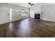 Open-concept living room featuring a fireplace, hardwood floors, and modern lighting at 1128 Peninsula Cove Dr, Charleston, SC 29492
