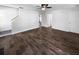A spacious living room is enhanced with beautiful wood-look flooring, a ceiling fan, and neutral paint at 1128 Peninsula Cove Dr, Charleston, SC 29492