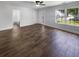 Spacious living room featuring hardwood floors, bright windows and a bathroom entrance at 1128 Peninsula Cove Dr, Charleston, SC 29492