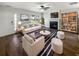 Bright living room featuring neutral furniture, a fireplace, hardwood floors, and a ceiling fan at 1128 Peninsula Cove Dr, Charleston, SC 29492