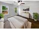 Bright main bedroom featuring hardwood floors, two windows, a dresser, and modern decor at 1128 Peninsula Cove Dr, Charleston, SC 29492