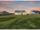 Spacious backyard showing ample green space and the rear exterior of a home at 1144 Wading Point Blvd, Huger, SC 29450