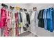 Organized walk-in closet with ample hanging space for clothes and bags, featuring white shelving and rods at 1144 Wading Point Blvd, Huger, SC 29450