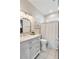 Bright bathroom featuring a marble vanity, modern fixtures, and a shower with stylish curtain at 116 W 2Nd St, Folly Beach, SC 29439