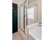 Bright bathroom showcasing a glass shower near a black door at 116 W 2Nd St, Folly Beach, SC 29439