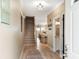 Inviting foyer featuring wood floors, a staircase, and views into the kitchen and dining area, creating an open feel at 116 W 2Nd St, Folly Beach, SC 29439