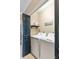 Well-lit laundry room featuring modern washer and dryer units behind a black door at 116 W 2Nd St, Folly Beach, SC 29439