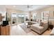 Bright living room featuring light-colored wood floors, a comfortable sectional sofa, and access to a screened porch at 116 W 2Nd St, Folly Beach, SC 29439