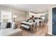 Open concept living space with kitchen island, dining table, and comfortable seating area, all with light-colored wood floors at 116 W 2Nd St, Folly Beach, SC 29439