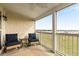 Relax on this covered patio with comfortable seating and a picturesque view of the water at 116 W 2Nd St, Folly Beach, SC 29439