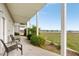 Covered patio with seating overlooking a grassy area and a water view at 116 W 2Nd St, Folly Beach, SC 29439