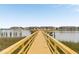 Picturesque pier extends over calm waters, offering stunning views of waterfront buildings, creating a tranquil retreat at 116 W 2Nd St, Folly Beach, SC 29439