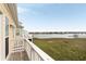 Expansive waterfront view featuring lush marshlands, a distant town, and clear skies above at 116 W 2Nd St, Folly Beach, SC 29439