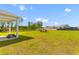 A well manicured backyard with chairs and a table with a view of neighboring homes at 1173 Wading Point Blvd, Huger, SC 29450