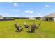 Backyard with an inviting fire pit surrounded by Adirondack chairs, creating a cozy outdoor space at 1173 Wading Point Blvd, Huger, SC 29450
