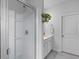 Bright bathroom features a glass shower, white cabinets, and tile flooring at 1173 Wading Point Blvd, Huger, SC 29450