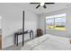 Bright bedroom features a four-poster bed, ceiling fan, and view to the outside at 1173 Wading Point Blvd, Huger, SC 29450
