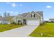 Inviting home with a lush green lawn, white trim, and a well-maintained driveway at 1173 Wading Point Blvd, Huger, SC 29450