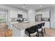 Bright kitchen with stainless appliances, granite countertops, a large island and wood floors at 1173 Wading Point Blvd, Huger, SC 29450