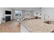 Open concept kitchen and living room boasts wood floors and large windows at 1173 Wading Point Blvd, Huger, SC 29450