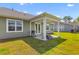 Covered patio with a grill and picnic table perfect for outdoor entertaining at 1173 Wading Point Blvd, Huger, SC 29450