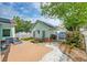 View of the backyard showcasing a detached garage, patio area, and manicured landscaping at 122 Foxglove Ave, Summerville, SC 29483