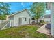 View of the home's backyard featuring a small lawn, white picket fence, and detached building at 122 Foxglove Ave, Summerville, SC 29483