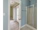 Well-lit bathroom featuring a glass-enclosed shower, tile flooring, and an ensuite room at 122 Foxglove Ave, Summerville, SC 29483