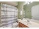Bathroom featuring a vanity with modern sink, a white shower curtain with black triangle design and green walls at 122 Foxglove Ave, Summerville, SC 29483