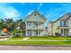 Charming two-story home with a double porch, well-manicured lawn, and mature landscaping at 122 Foxglove Ave, Summerville, SC 29483