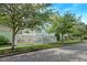 Charming light green home with a white picket fence and lush greenery in a residential neighborhood at 122 Foxglove Ave, Summerville, SC 29483