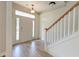 Bright foyer with wood-look floors, a staircase with white risers, and a front door with sidelights at 122 Foxglove Ave, Summerville, SC 29483