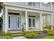Inviting front porch with a porch swing, well-manicured landscaping, and classic design at 122 Foxglove Ave, Summerville, SC 29483