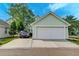 Attached two-car garage with driveway parking and well-maintained landscaping around the property at 122 Foxglove Ave, Summerville, SC 29483