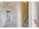 Hallway with staircase leading up and view into a bathroom with black and white striped shower curtain at 122 Foxglove Ave, Summerville, SC 29483
