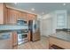 Kitchen with stainless steel appliances, light wood cabinets, and white subway tile backsplash at 122 Foxglove Ave, Summerville, SC 29483