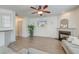 Comfortable living room with fireplace, ceiling fan, wood-look floors, and ample natural light at 122 Foxglove Ave, Summerville, SC 29483